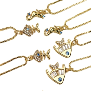 Gold ocean necklaces with seahorse and fishbone pendants set with blue and white zircon
