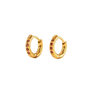 Detail view of 18K gold plated stainless steel huggie earrings with five red zircon stones