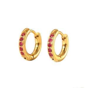 Detail of 18K PVD gold plated huggie earrings with six inlaid red round cubic zirconia stones
