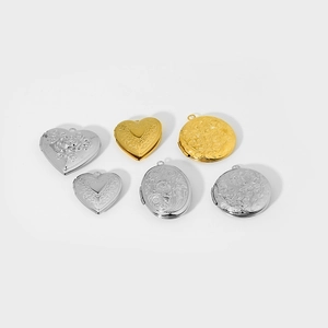 Detailed flat lay of heart and oval locket pendants with vintage floral engravings