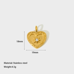 Detailed view of heart-shaped stainless steel pendant with starburst engraving and zircon
