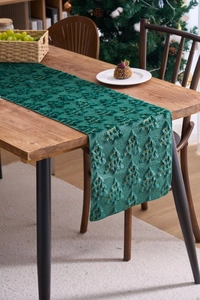 Detailed close-up of dark green velvet Christmas table runner with gold tree embroidery