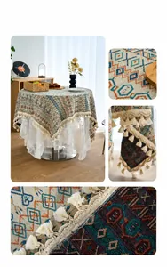 Macro view of floral jacquard tablecloth with pom-pom fringe and lace layering