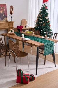 Detailed close-up of dark green Christmas table runner with 3D embossed tree pattern