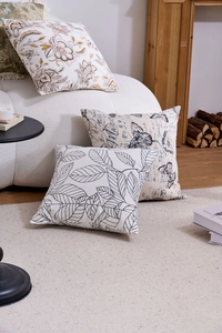 Cozy living room set featuring floral and butterfly pattern cushion covers on sofa