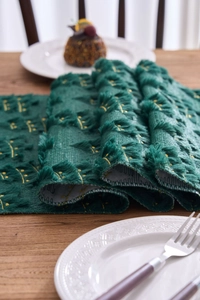 Detailed view of forest green plush embroidery table runner with gold moon embroidery