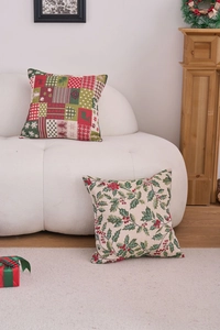 Detail of Christmas jacquard cushion covers with festive holly and patchwork patterns