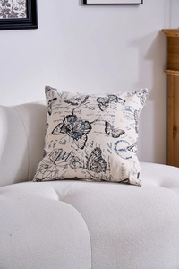 Detailed macro view of vintage butterfly pattern on linen pillowcase with retro stamps