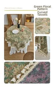 Detail of round green pastoral floral tablecloth with curved fringe and jacquard texture
