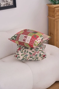 Close-up of American jacquard Christmas pillow with reindeer and holly patterns on sofa