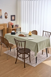 Close-up of green and white striped tablecloth with delicate white lace edge