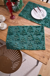 Detail of forest green plush table mat with 3D Christmas tree embroidery and gold threads