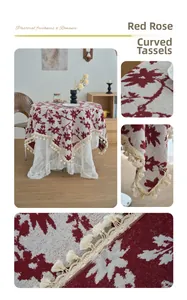 Detail of vintage floral tablecloth with red rose pattern and curved fringe tassels