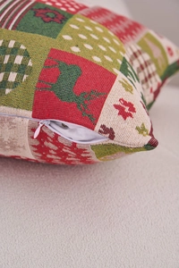 Close-up of white invisible zipper on Christmas patchwork pillowcase with deer patterns