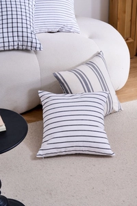 Close-up of geometric cushion covers with hidden zipper on a modern white sofa