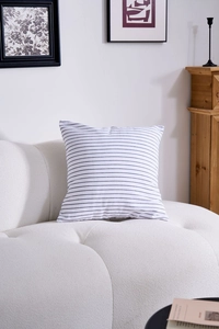 Detail of square striped pillowcase with black and blue lines on a modern sofa