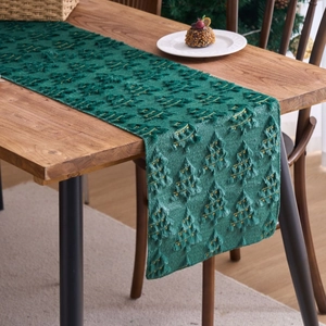 Dark green Christmas table runner with embroidered trees on solid wood dining table