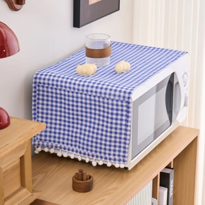 Blue plaid dust cover with pom-pom trim for microwave or small household appliances
