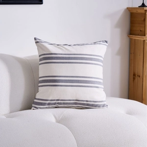 Modern geometric striped square pillow case on a white sofa for home living room decor