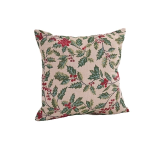 Christmas pillow case featuring green holly leaves and red berries on beige woven fabric