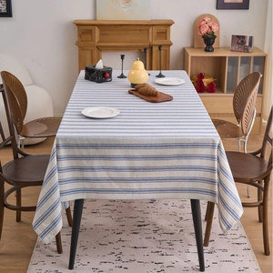 Japanese style blue and white striped linen tablecloth with lace edges on wooden table
