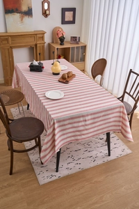 Detail shot of the cotton linen tablecloth featuring a classic red and white striped pattern