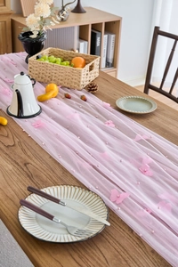 Detail of pink lace table runner with 3D butterfly embroidery and small pearls