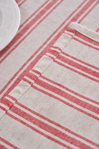 Close-up of red and white striped linen tablecloth with neat flat-seam edge stitching