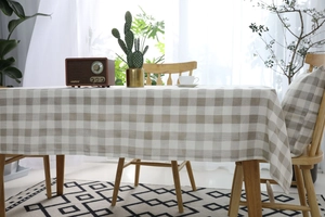 Primer plano detallado del mantel de cuadros beige y gris claro con textura de tela de calidad
