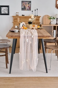Detail of lace table runner with 3D butterfly appliques and small pearl beads