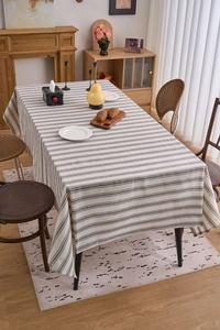 Close-up of Japanese style striped linen tablecloth on a wooden table in home setting