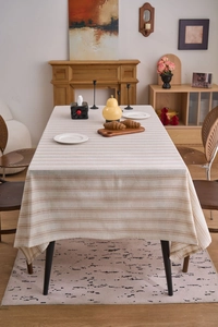 Detailed view of striped linen tablecloth with high-quality beige and brown woven texture
