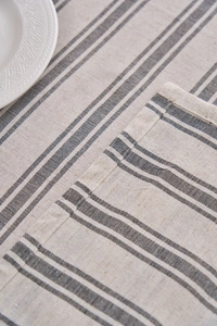 Detail shot of cotton linen striped tablecloth showing high-quality fabric texture and stitching