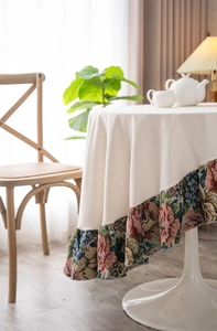 Close-up of floral jacquard hem on minimalist round tablecloth for a vintage rustic dining set