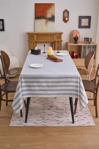Close-up of blue and white striped cotton linen tablecloth with lace edge detail