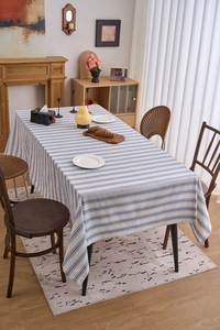 Detailed top view of blue and white striped cotton linen tablecloth with lace edges