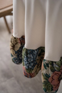 Close-up of vintage floral ruffle edge and cream fabric on a high-quality tablecloth