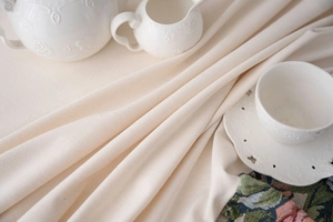 Detailed view of oatmeal textured cotton linen fabric with soft natural drape and weave