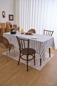 Close-up of blue and white striped linen tablecloth with delicate lace edge detail