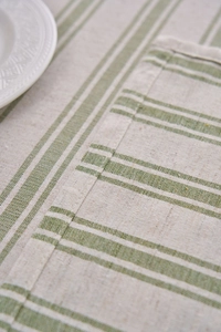 Close-up of green and beige striped linen tablecloth showing fine hemmed edges and texture