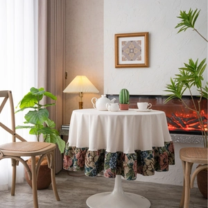 French vintage round tablecloth with floral ruffled edges in a warm home setting