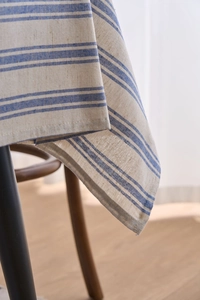 Close-up of blue and white striped cotton linen tablecloth with natural woven texture details