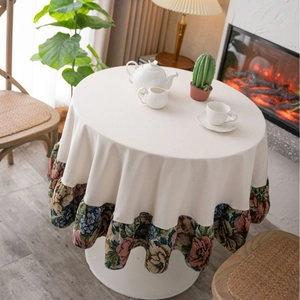 Vintage round tablecloth with floral ruffled edge in cozy rustic dining room setting