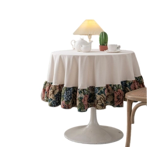Elegant round tablecloth in cream fabric with vintage floral ruffles for dining