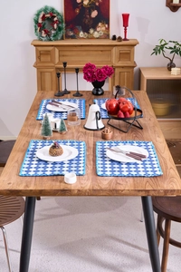 Set of four blue and white argyle fabric placemats with crochet lace edges on a wooden table