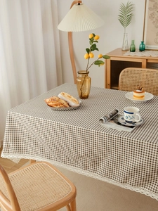 Close-up of brown and white checkered tablecloth with delicate white lace edge