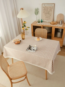 Detail of strawberry heart pattern linen tablecloth with decorative white lace edges