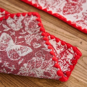 Red jacquard placemat with butterfly floral patterns and scalloped crochet border edges