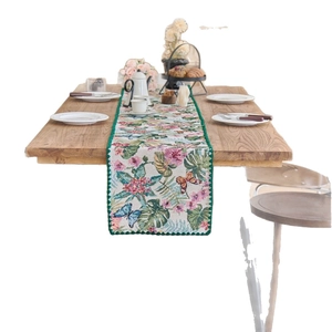 Floral table runner with tropical palm leaves and butterflies on wood table