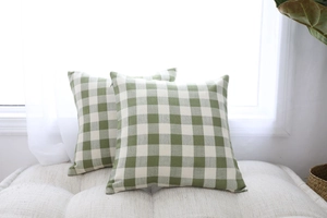 Detail of green and white gingham pillow covers with woven texture and hidden zipper